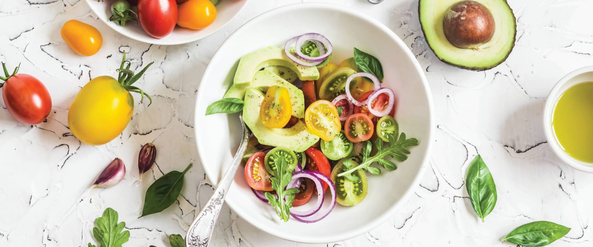 close up of a healthy salad with veggies on top and surrounding it