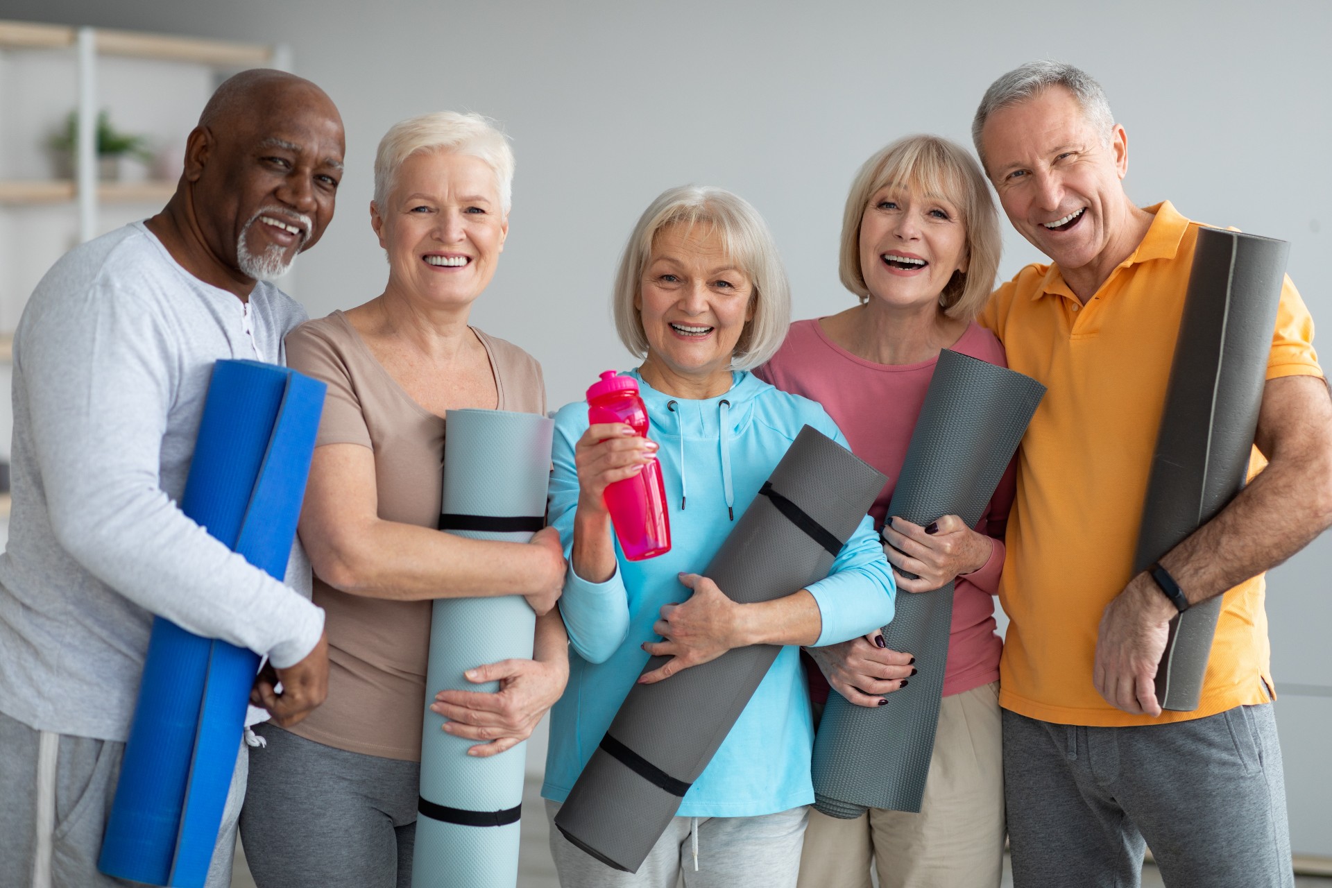 Happy group of seniors attending a yoga class