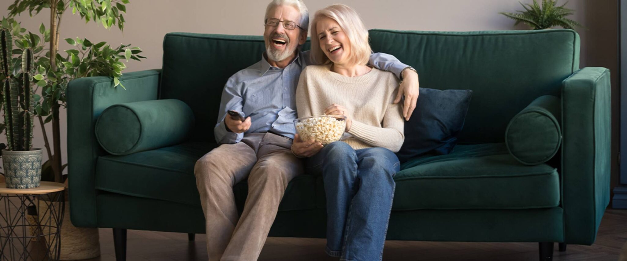 senior couple enjoying a movie marathon in their senior apartment