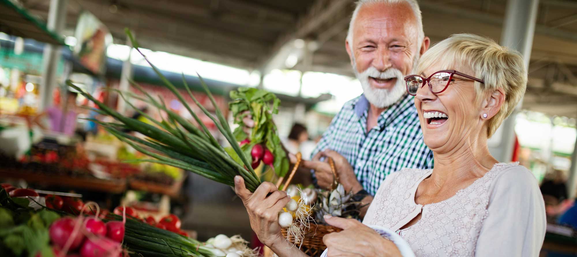 Elderly couple picking vegetables at a farmer's market