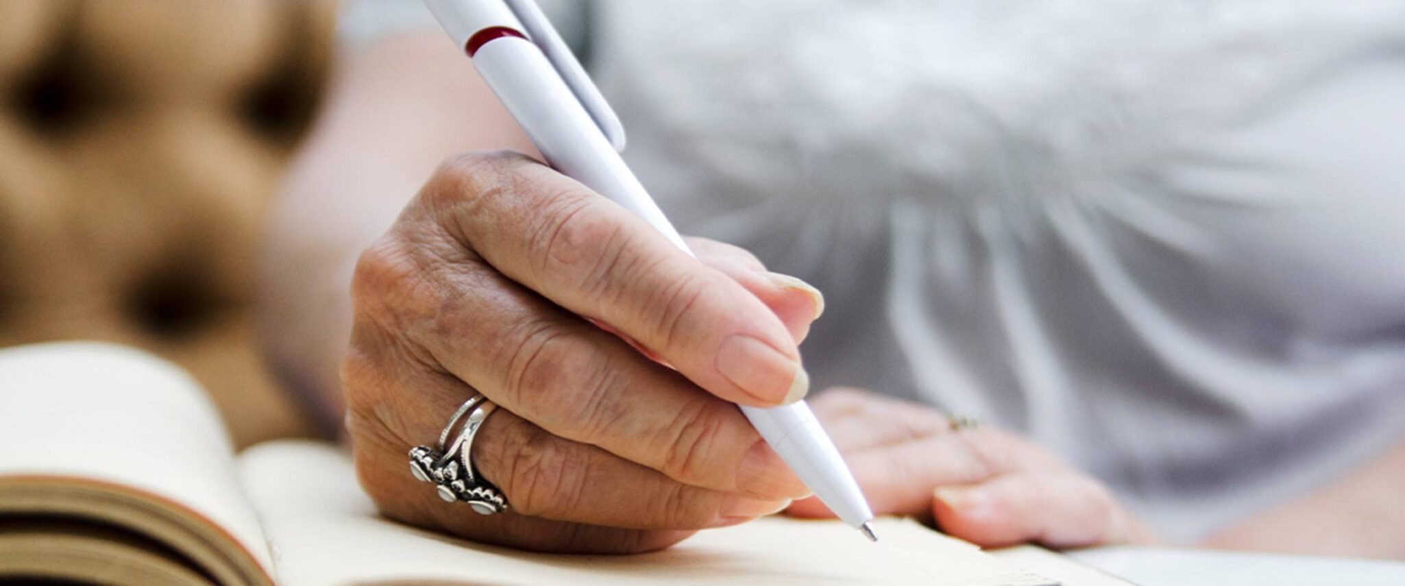 senior writing in a notebook at a retirement community
