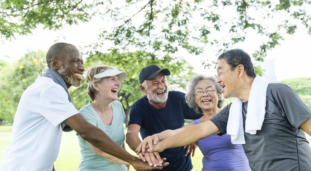 Happy senior friends exercising together