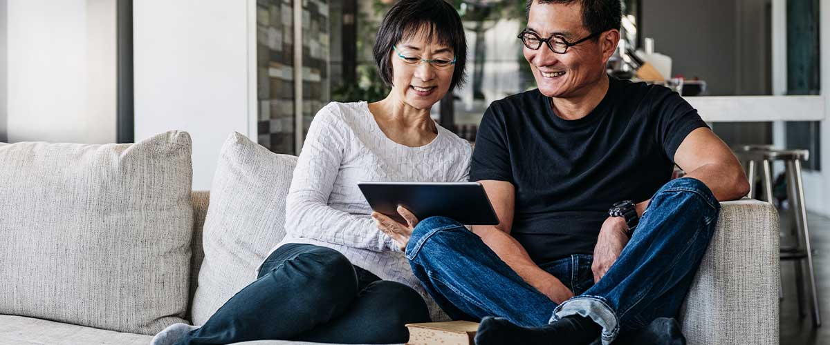 Elderly couple enjoying tv inside their Lake Seminole Square apartment