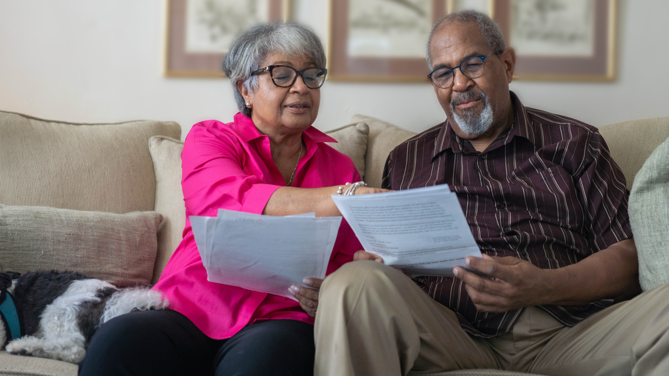 Senior couple looking over paperwork together