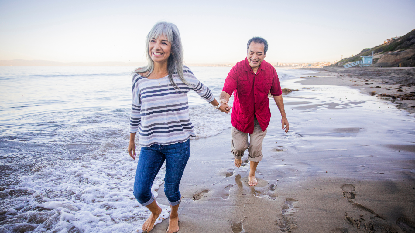Senior couple walking on beach