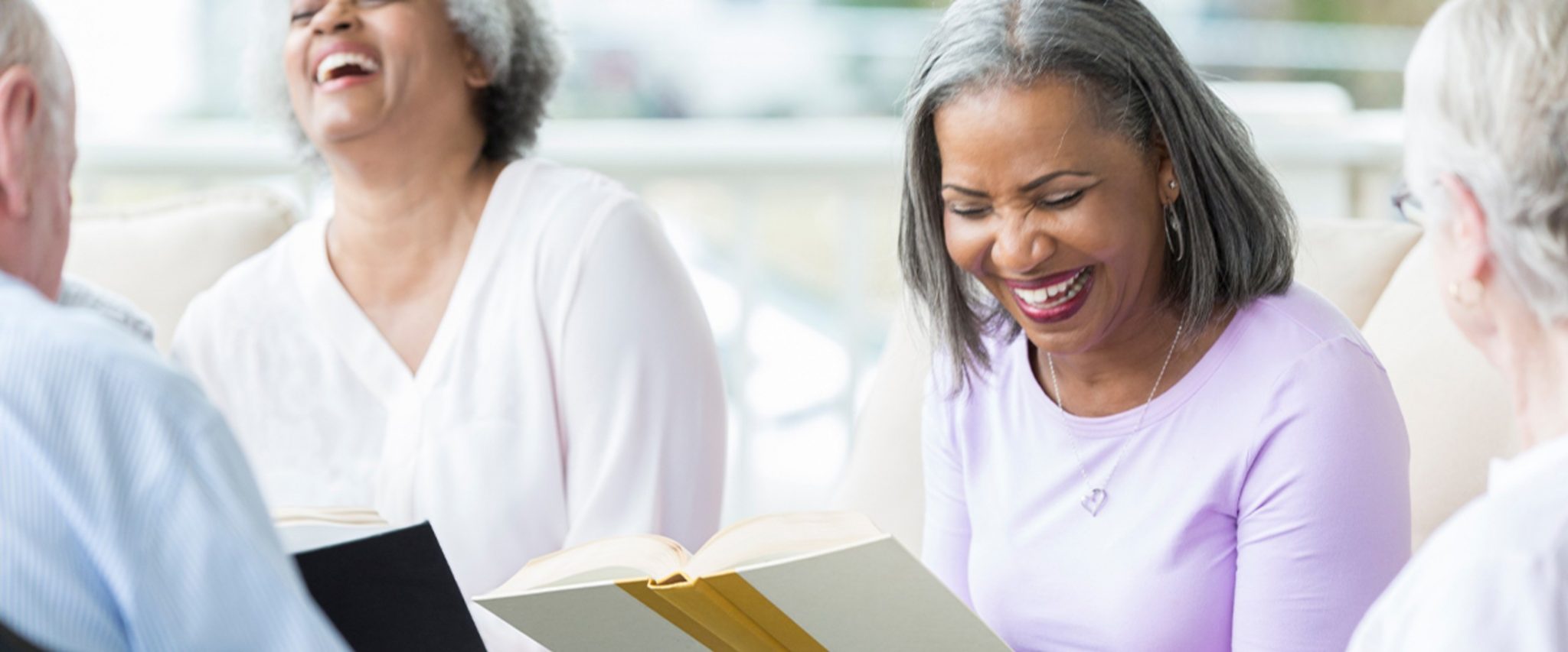 seniors participate in a book club at senior living community