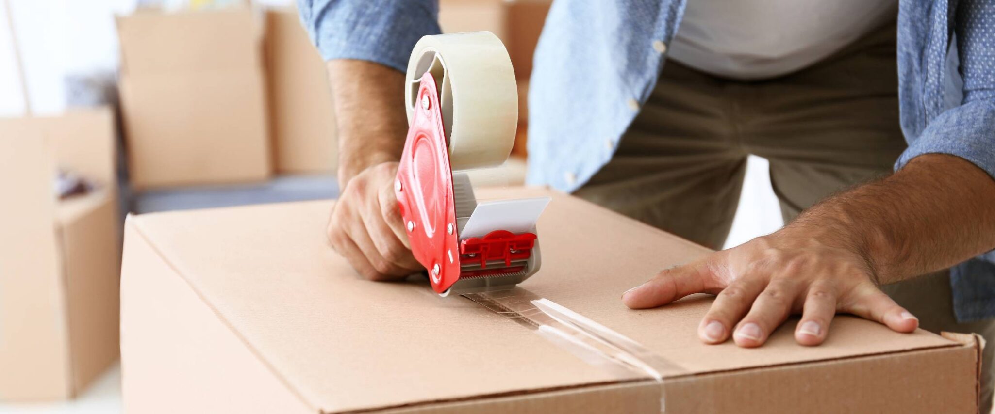 senior packing up boxes to downsize to an assisted living apartment