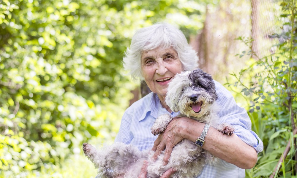 Happy senior woman with her dog