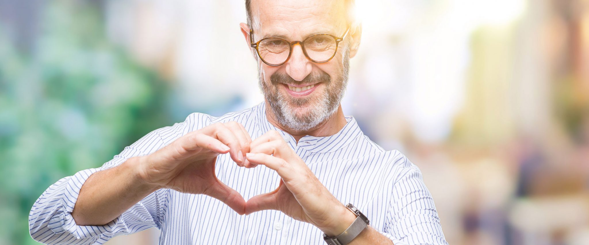 man shapes a heart with his fingers