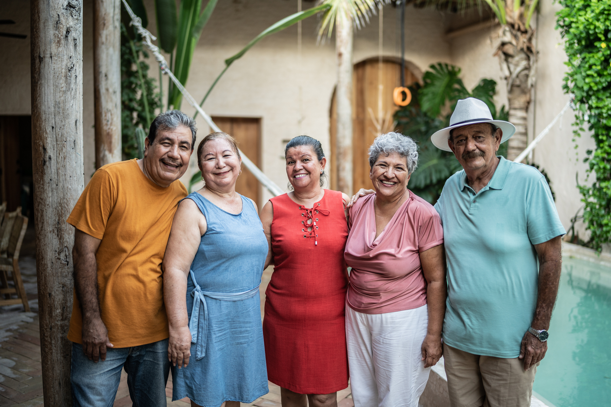 Group of smiling senior friends by pool